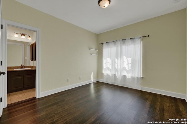 spare room featuring dark hardwood / wood-style flooring and sink