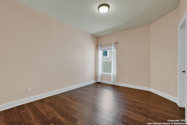 unfurnished room featuring dark hardwood / wood-style floors