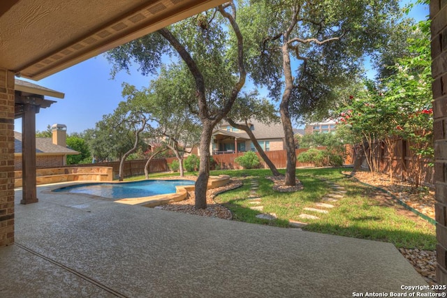 view of swimming pool featuring a patio and a lawn