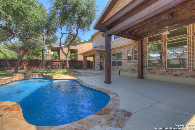 view of swimming pool featuring a patio and ceiling fan