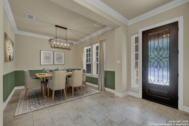 interior space featuring ornamental molding, a chandelier, and a wealth of natural light