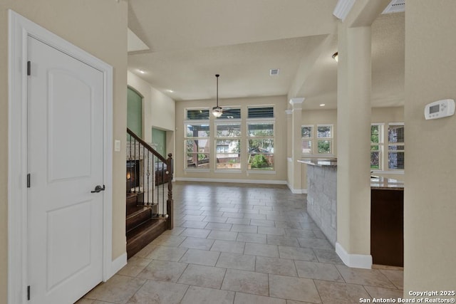 tiled foyer featuring ceiling fan