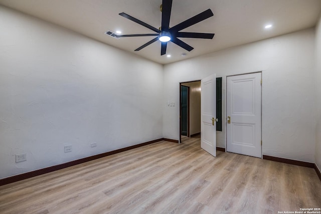 unfurnished bedroom with ceiling fan and light wood-type flooring