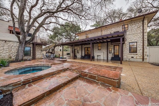 view of swimming pool featuring a patio and an in ground hot tub