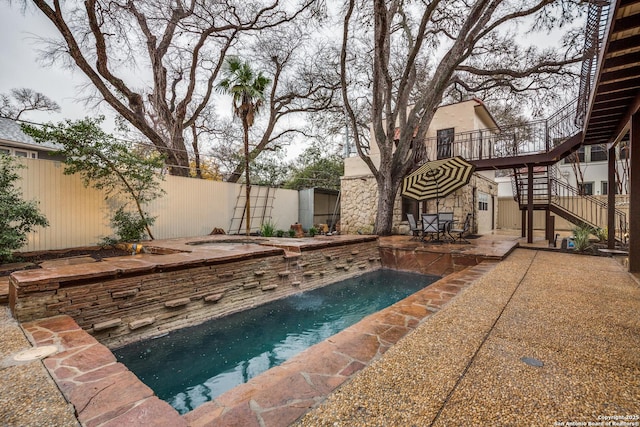 view of swimming pool featuring a patio area and a hot tub