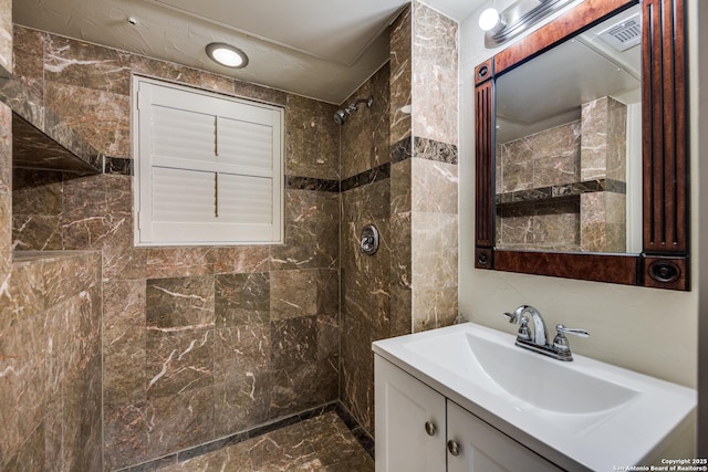 bathroom featuring vanity and a tile shower