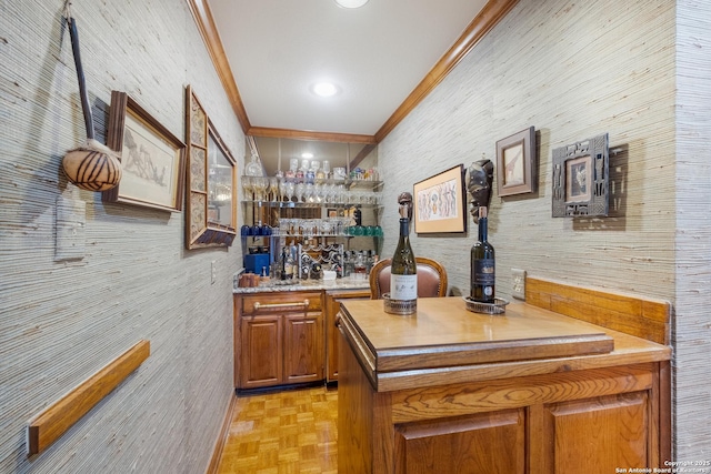 bar with ornamental molding and light parquet flooring