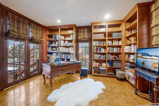 home office featuring light parquet flooring, built in features, and french doors