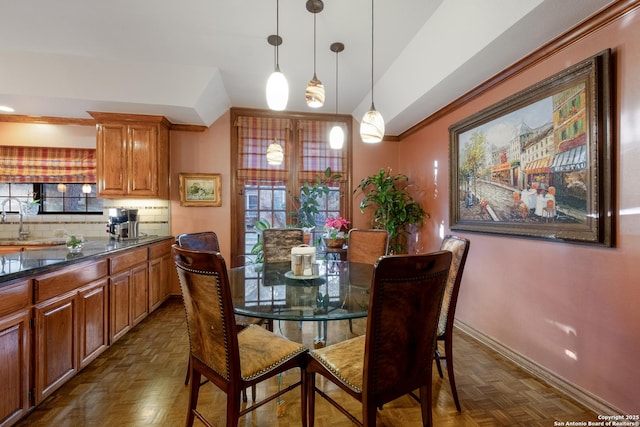 dining area featuring crown molding and dark parquet floors