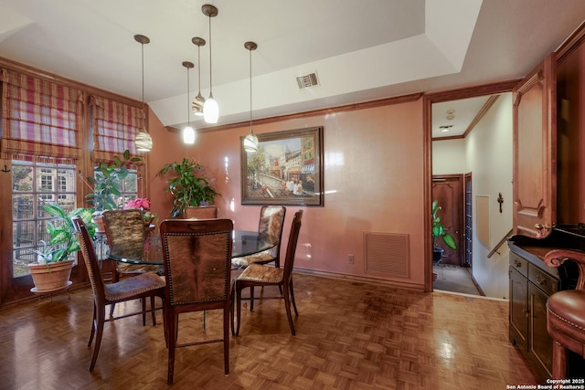 dining area featuring crown molding and dark parquet floors