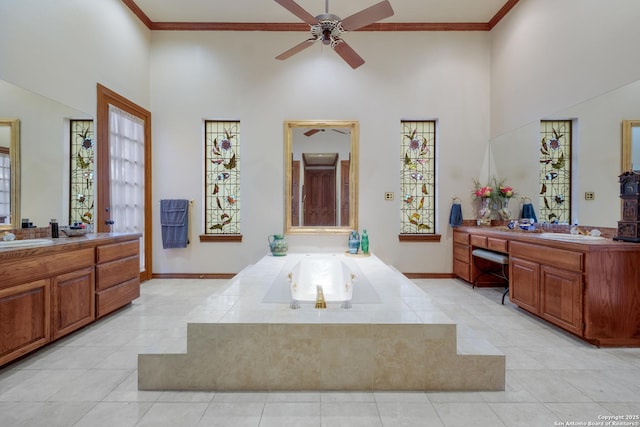 bathroom with vanity, crown molding, and a towering ceiling