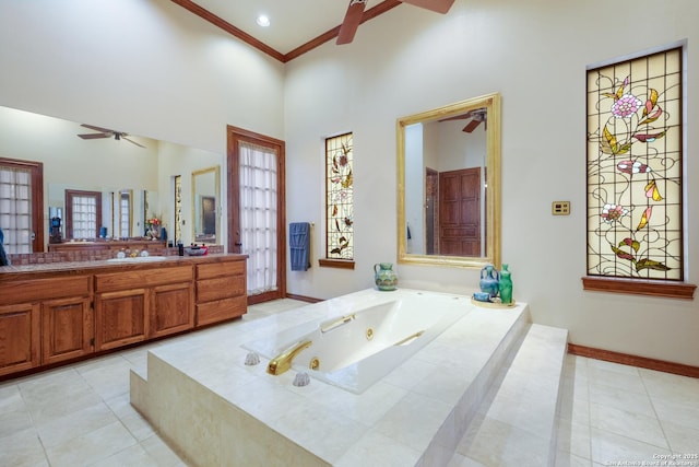 bathroom featuring a towering ceiling, tile patterned flooring, ornamental molding, ceiling fan, and tiled tub