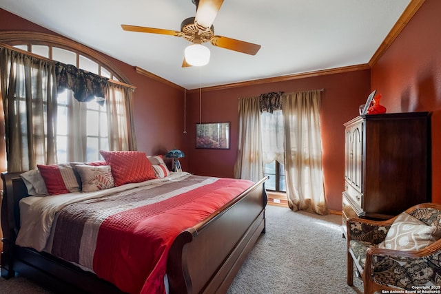 bedroom featuring ornamental molding, light colored carpet, and ceiling fan