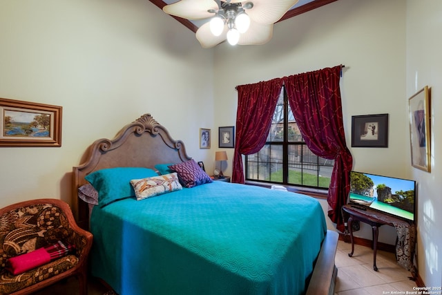 tiled bedroom featuring ceiling fan