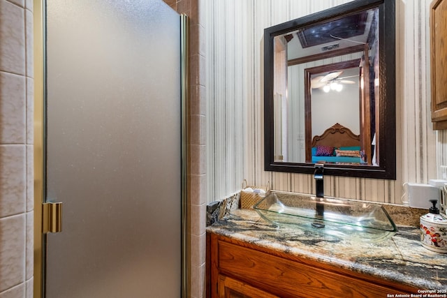 bathroom featuring vanity and a shower with shower door