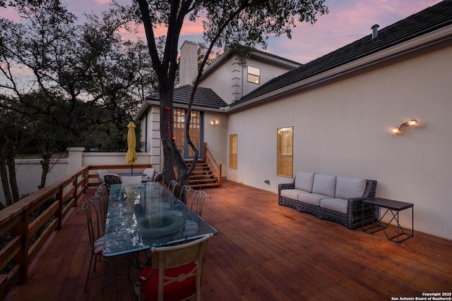 deck at dusk with an outdoor living space