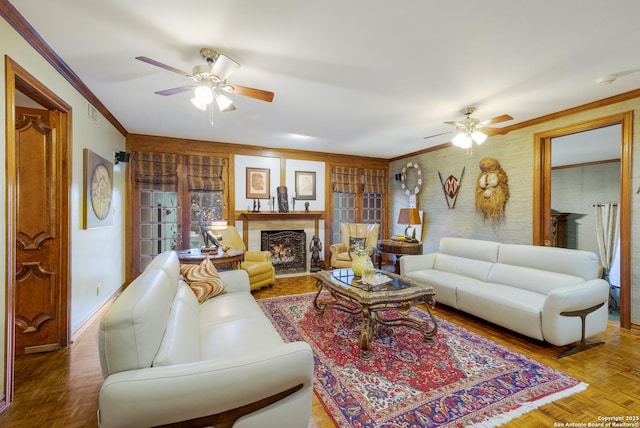 living room with parquet floors, crown molding, and ceiling fan