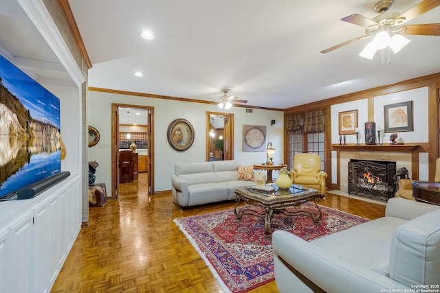 living room featuring ceiling fan, crown molding, and light parquet flooring