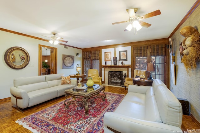 living room with parquet floors, ceiling fan, and ornamental molding