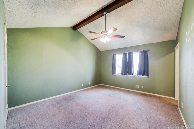 unfurnished room featuring ceiling fan, carpet flooring, a textured ceiling, and vaulted ceiling with beams