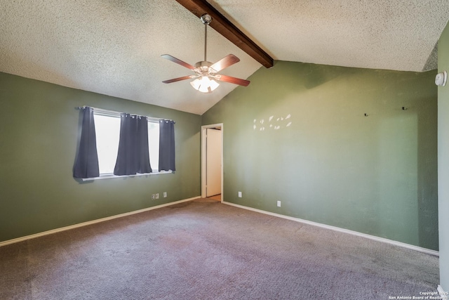 unfurnished room with carpet floors, vaulted ceiling with beams, ceiling fan, and a textured ceiling