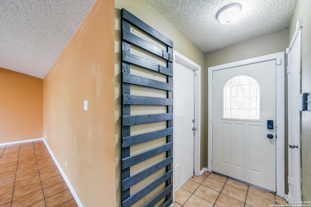 tiled entrance foyer with a textured ceiling