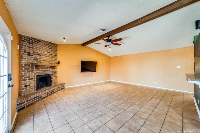 unfurnished living room featuring light tile patterned flooring, lofted ceiling with beams, ceiling fan, a brick fireplace, and a textured ceiling