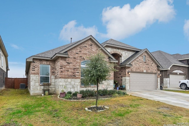 view of front of home with central AC, a garage, and a front lawn