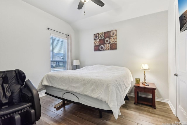 bedroom with lofted ceiling, hardwood / wood-style floors, and ceiling fan