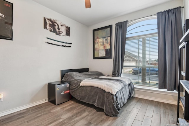 bedroom with hardwood / wood-style floors and ceiling fan