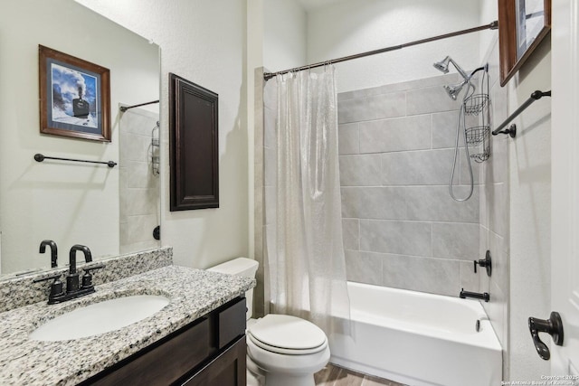 full bathroom with vanity, shower / tub combo, and toilet