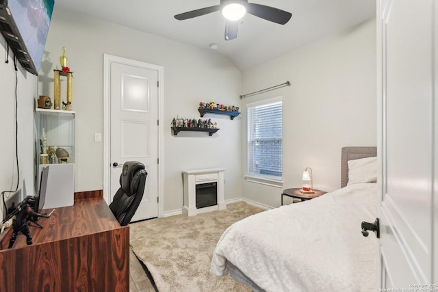 carpeted bedroom with lofted ceiling, a fireplace, and ceiling fan