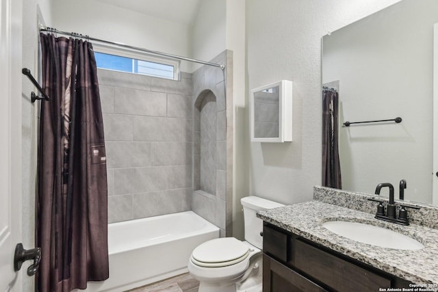 full bathroom featuring vanity, shower / tub combo, and toilet