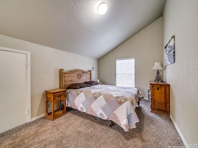 bedroom featuring vaulted ceiling, carpet, and a textured ceiling