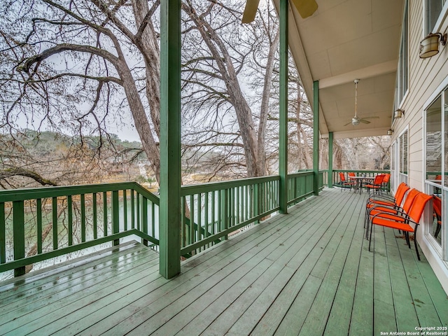 wooden terrace with a mountain view and ceiling fan