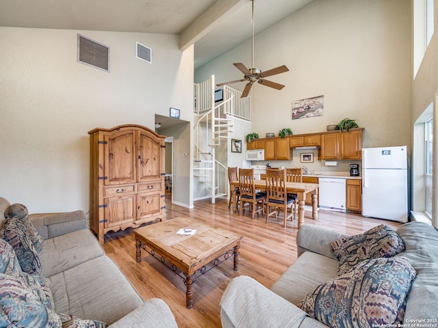 living room with ceiling fan, lofted ceiling, sink, and light hardwood / wood-style floors