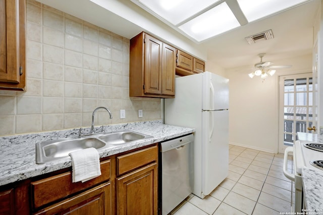 kitchen with light tile patterned flooring, tasteful backsplash, sink, stainless steel dishwasher, and electric stove