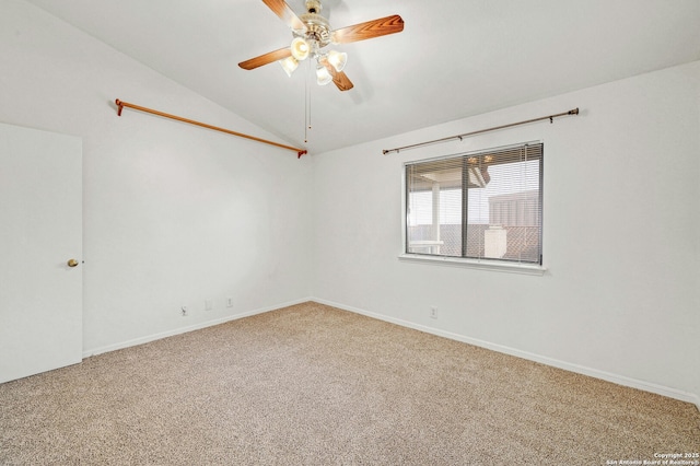 spare room featuring lofted ceiling, carpet, and ceiling fan