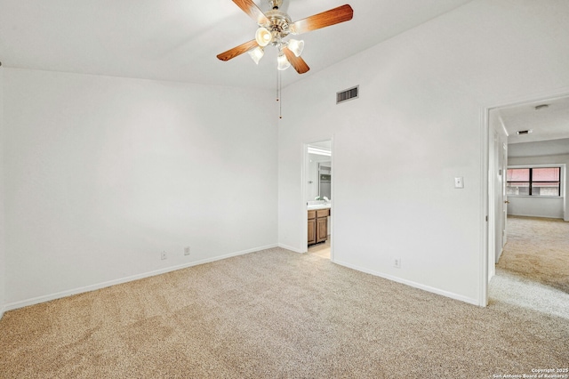 spare room featuring light carpet and ceiling fan