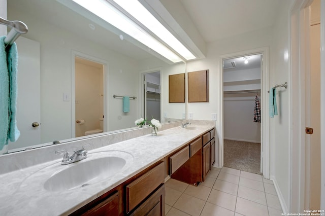 bathroom with vanity, tile patterned floors, and toilet