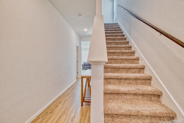 stairs with wood-type flooring