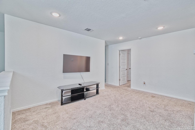 living room featuring light colored carpet and a textured ceiling