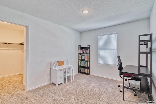 office with light carpet and a textured ceiling