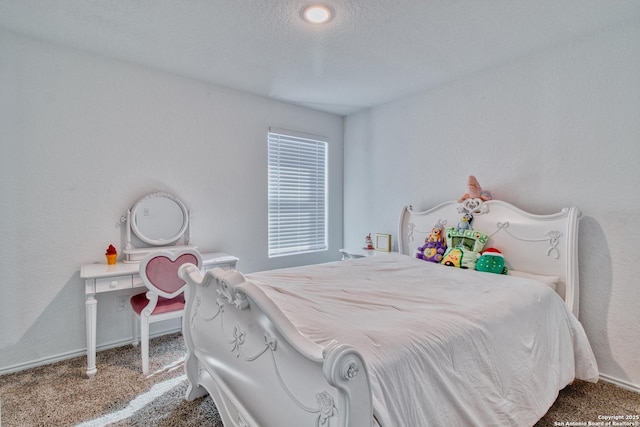 bedroom with carpet and a textured ceiling