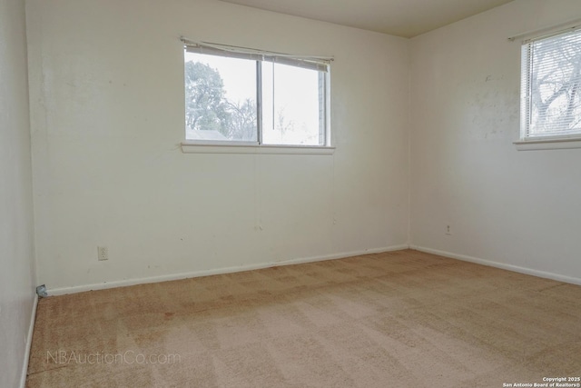 unfurnished room with carpet flooring and baseboards