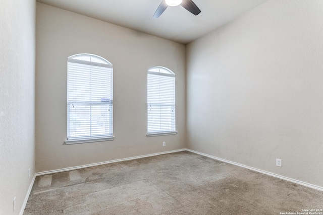 spare room featuring light carpet and ceiling fan