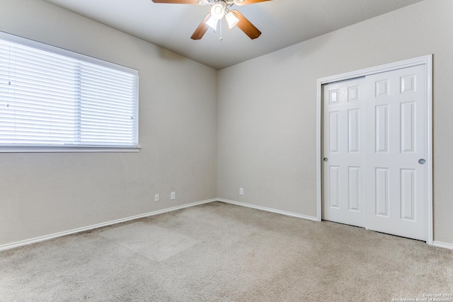 carpeted empty room with ceiling fan