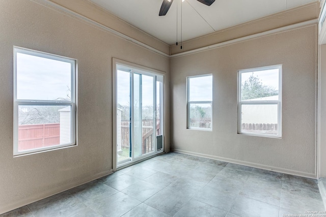 spare room with crown molding and ceiling fan