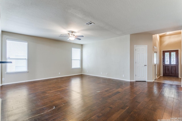 unfurnished room with ceiling fan, dark hardwood / wood-style floors, and a textured ceiling