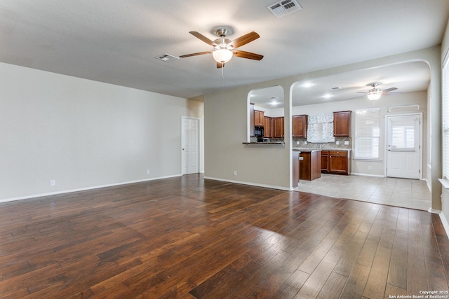 unfurnished living room with hardwood / wood-style floors and ceiling fan